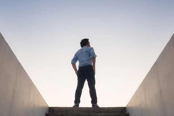 Man at top of stairs looking at sky