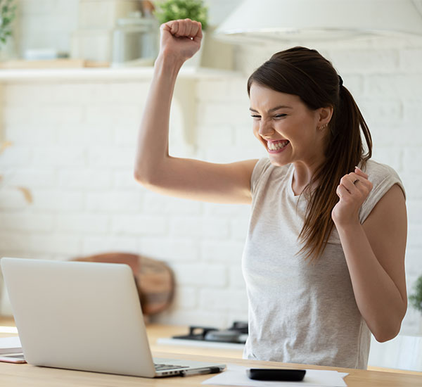 Women excitedly looking at her laptop